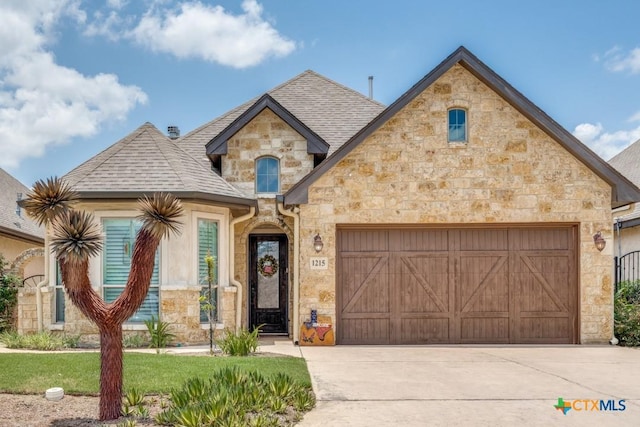 1215 Gruene Vintage, New Braunfels, TX 78130 - french provincial home with stone siding, a garage, driveway, and a shingled roof