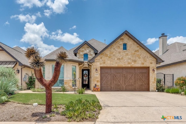 1215 Gruene Vintage, New Braunfels, TX 78130 - french country home with stone siding, a garage, and concrete driveway