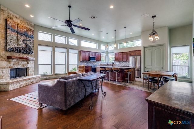 1215 Gruene Vintage, New Braunfels, TX 78130 - living room with a ceiling fan, dark wood-style floors, recessed lighting, a fireplace, and a towering ceiling