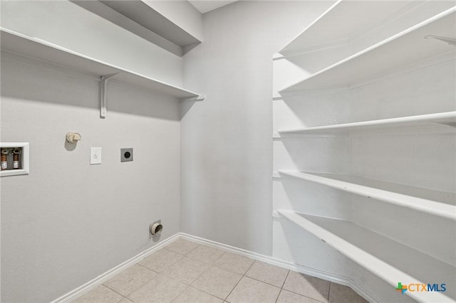6902 Golden Oak Ln, Killeen, TX 76542 - laundry room featuring hookup for a washing machine, electric dryer hookup, gas dryer hookup, baseboards, and tile patterned flooring