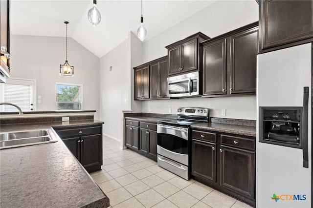 6902 Golden Oak Ln, Killeen, TX 76542 - kitchen featuring stainless steel appliances, a sink, light tile patterned floors, pendant lighting, and dark countertops