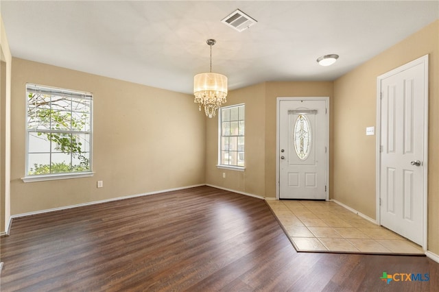 3628 Tilden Trl, New Braunfels, TX 78132 - foyer entrance with healthy amount of natural light, a chandelier, wood finished floors, and baseboards