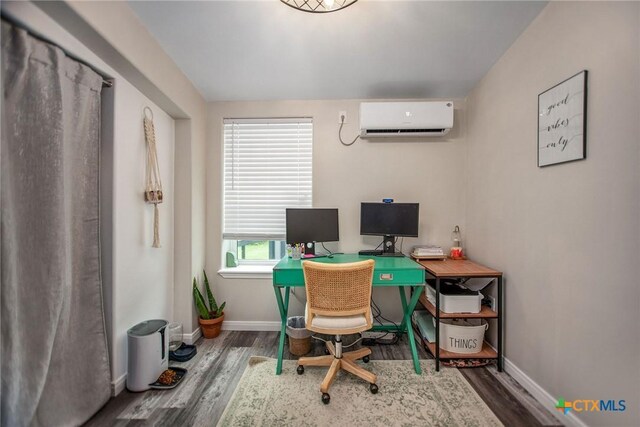 807 W Dallas Ave, Seadrift, TX 77983 - office area with baseboards, a wall unit AC, and wood finished floors