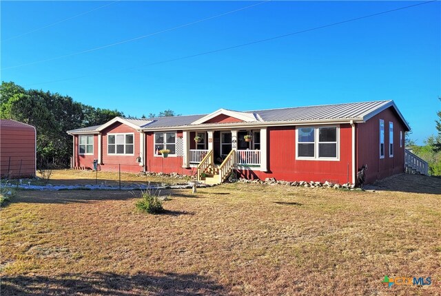 ranch-style house with a porch and a front yard