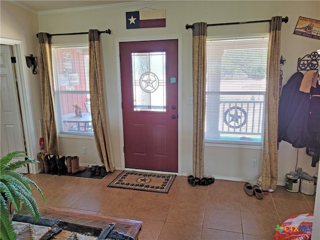 tiled foyer featuring crown molding