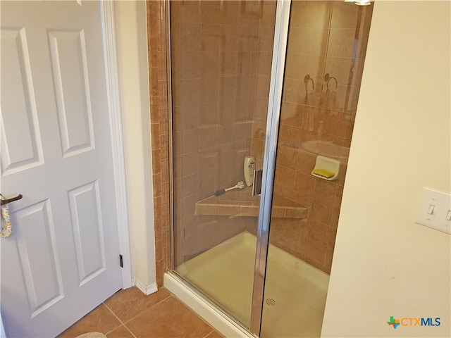 bathroom with tile patterned floors and walk in shower