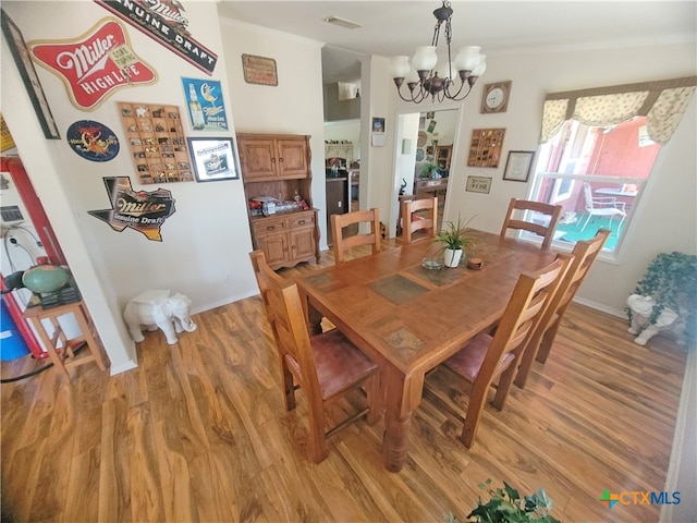 dining room featuring a notable chandelier and light hardwood / wood-style floors