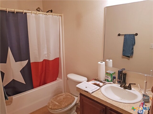 full bathroom with vanity, shower / tub combo, and toilet