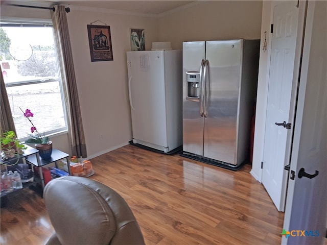 kitchen featuring stainless steel fridge, white fridge, plenty of natural light, and hardwood / wood-style floors