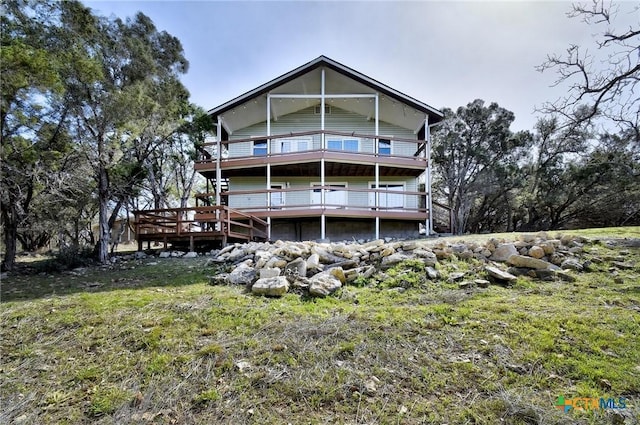 rear view of property featuring a lawn