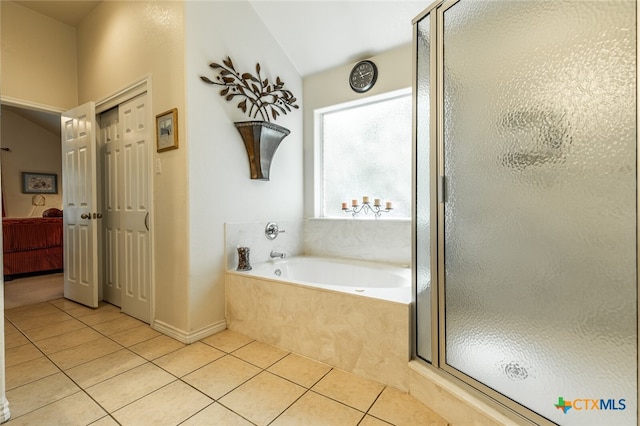 bathroom featuring vaulted ceiling, tile patterned flooring, and separate shower and tub