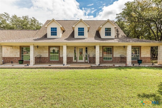 1199 Frederick Ln, Temple, TX 76502 - new england style home featuring a front yard, a porch, a shingled roof, and stone siding