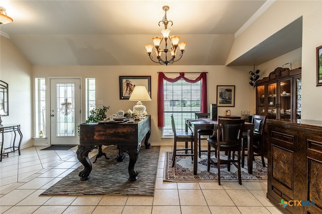 dining area featuring crown molding, light tile patterned floors, an inviting chandelier, and vaulted ceiling