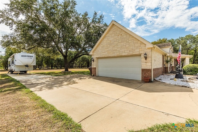 view of side of home featuring a garage