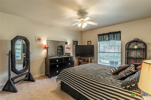 bedroom with ceiling fan and light colored carpet