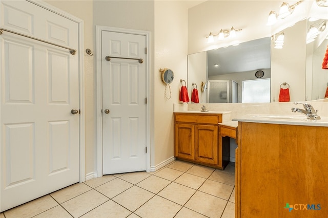 bathroom featuring vanity, tile patterned floors, and a shower with door