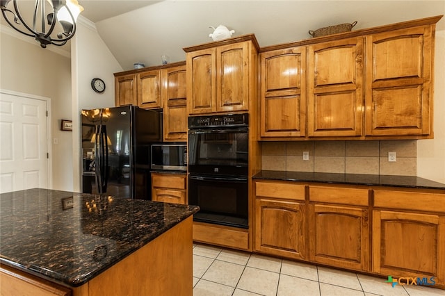 kitchen featuring light tile patterned flooring, black appliances, dark stone countertops, vaulted ceiling, and decorative backsplash