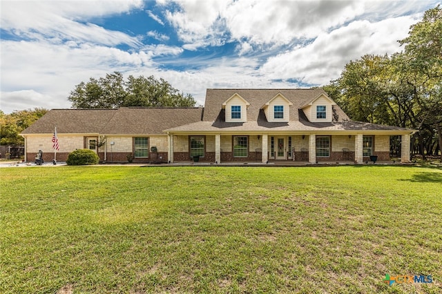 view of front of property with covered porch and a front yard