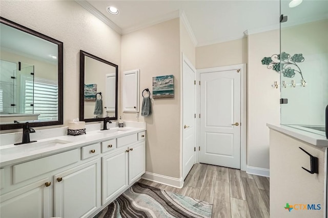 bathroom with vanity, ornamental molding, and wood-type flooring