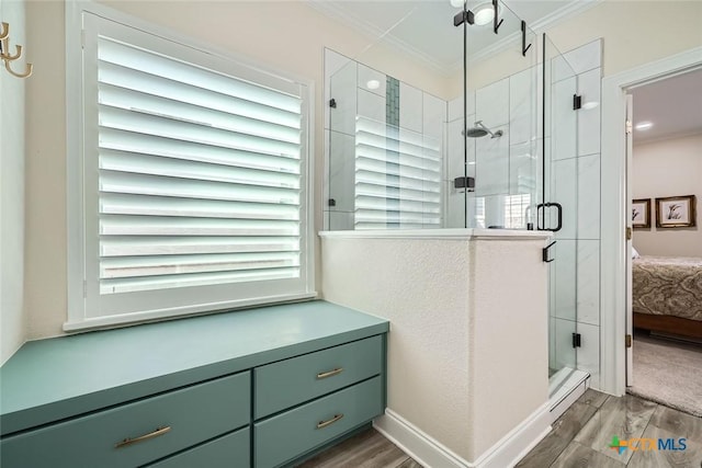 bathroom featuring hardwood / wood-style floors, an enclosed shower, and ornamental molding