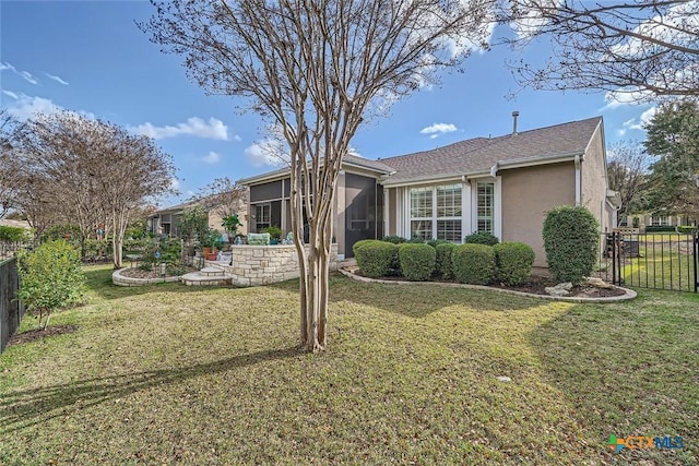 ranch-style home with a front lawn and a sunroom