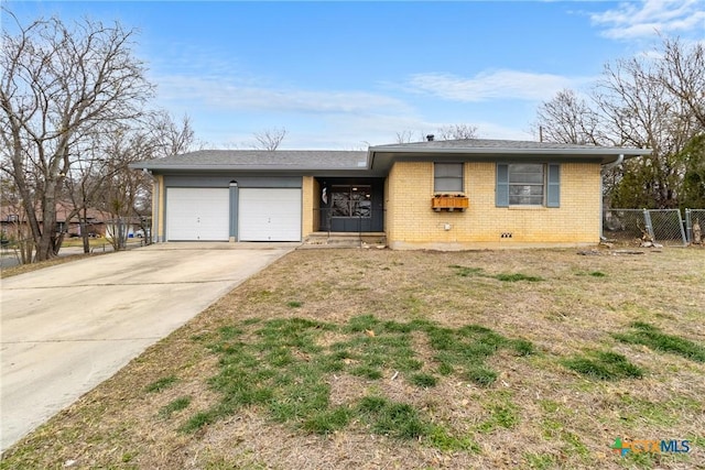 single story home featuring a garage and a front lawn