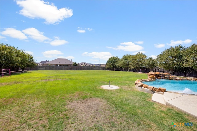 view of yard featuring pool water feature and a fenced in pool