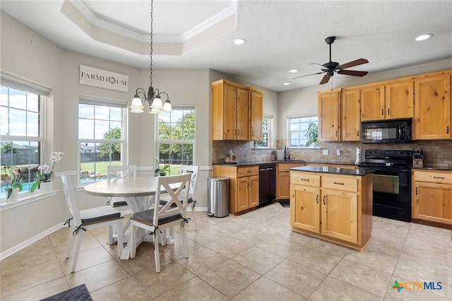 kitchen featuring pendant lighting, a wealth of natural light, ornamental molding, and black appliances