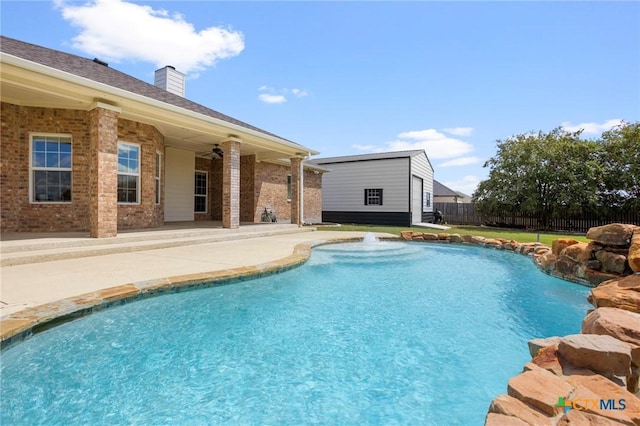 view of swimming pool featuring ceiling fan and a patio