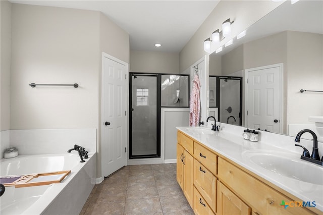 bathroom featuring plus walk in shower, vanity, and tile patterned floors