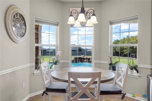 tiled dining room featuring an inviting chandelier