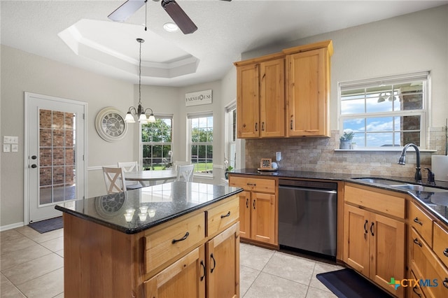 kitchen featuring decorative backsplash, sink, pendant lighting, dishwasher, and a kitchen island