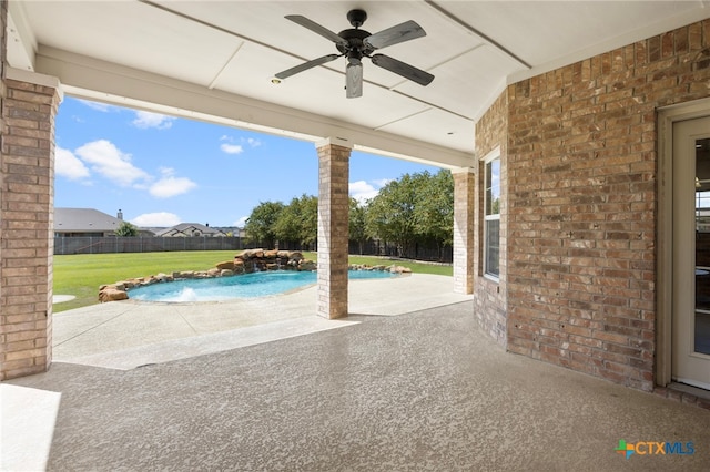 exterior space featuring a fenced in pool, ceiling fan, and pool water feature