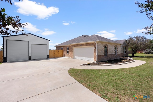 view of front of house featuring a garage and a front lawn