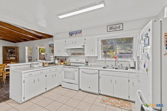 kitchen with lofted ceiling with beams, white appliances, sink, and plenty of natural light