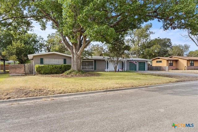 1415 Dove Ln, Seguin, TX 78155 - view of front facade featuring an attached garage and asphalt driveway
