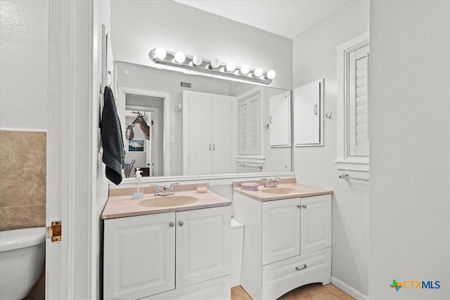 bathroom with vanity and toilet