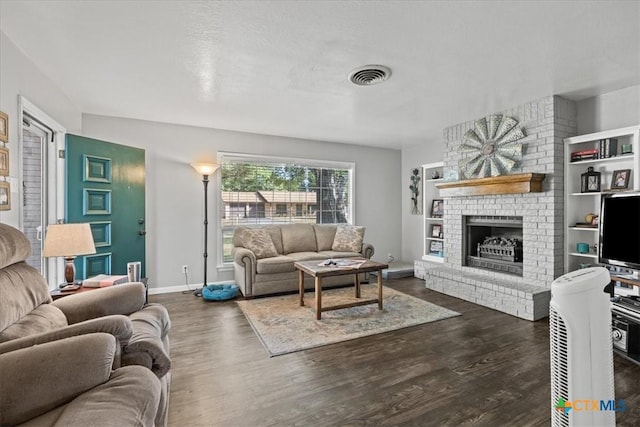1415 Dove Ln, Seguin, TX 78155 - living room featuring dark wood finished floors, a fireplace, and baseboards