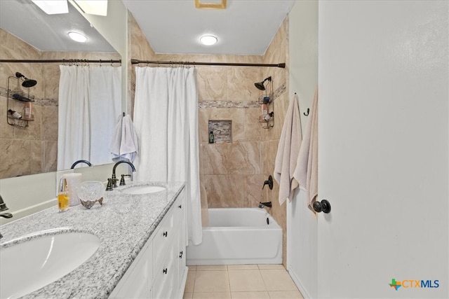 bathroom featuring vanity, shower / bath combo with shower curtain, and tile patterned floors