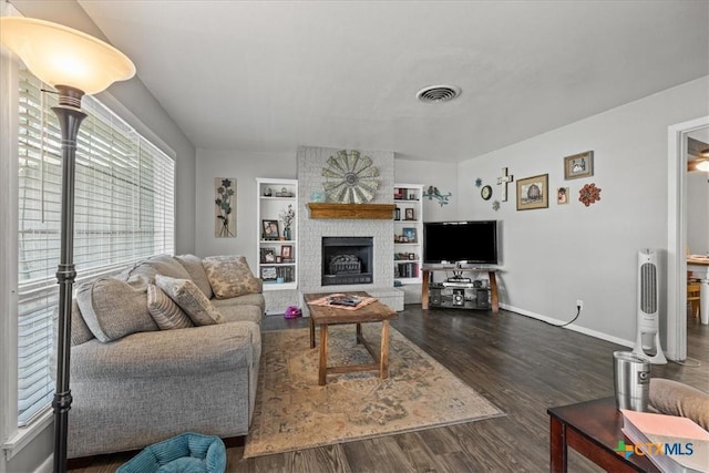 1415 Dove Ln, Seguin, TX 78155 - living area featuring dark wood finished floors, a fireplace, baseboards, and built in features