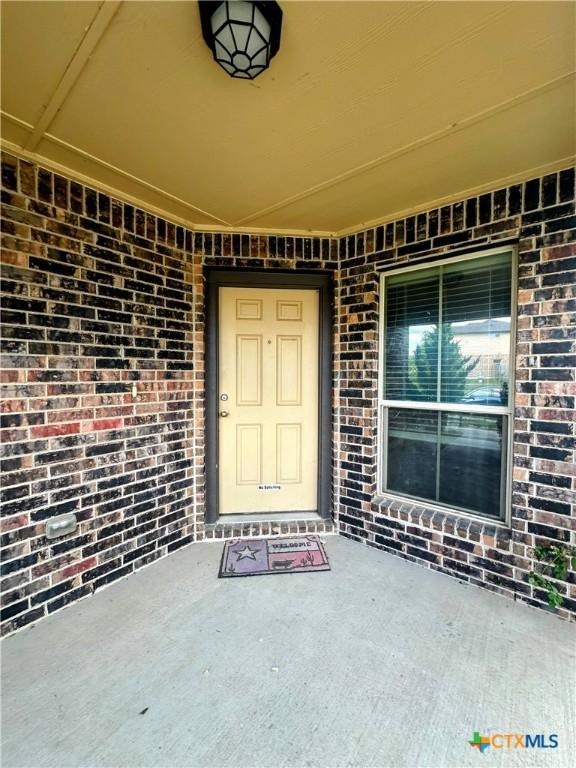 property entrance with brick siding