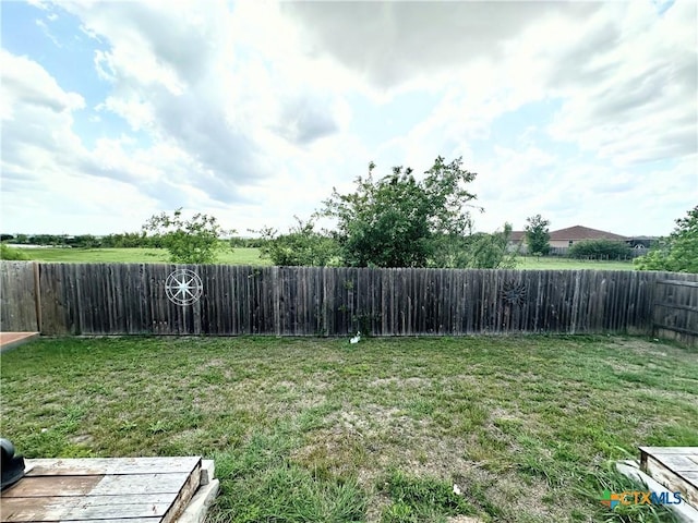 view of yard with a fenced backyard