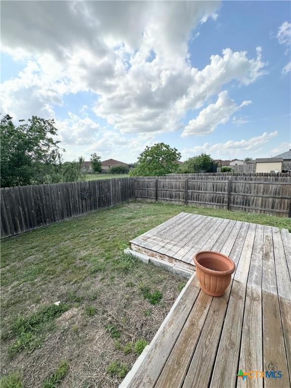 view of yard with a fenced backyard and a deck