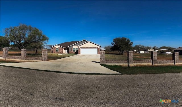 ranch-style house featuring a garage and a front lawn