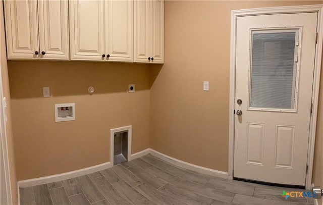 clothes washing area with cabinets, hookup for a washing machine, gas dryer hookup, and electric dryer hookup