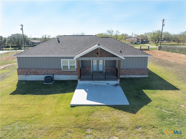 back of house with a lawn, a patio area, and central air condition unit