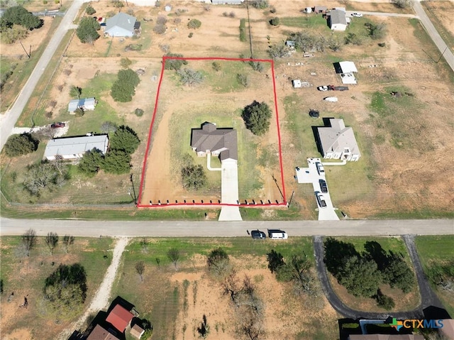 birds eye view of property featuring a rural view