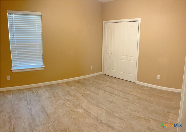 unfurnished bedroom with a closet