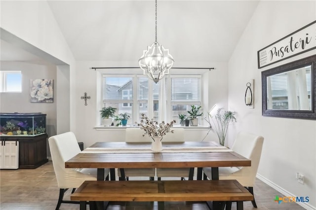 dining room with an inviting chandelier, lofted ceiling, and a wealth of natural light