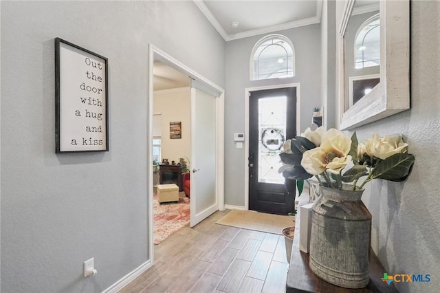 entryway featuring crown molding